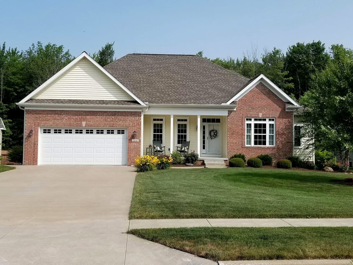 Custom brick home with porch by Gene Laughner Construction in Erie, PA
