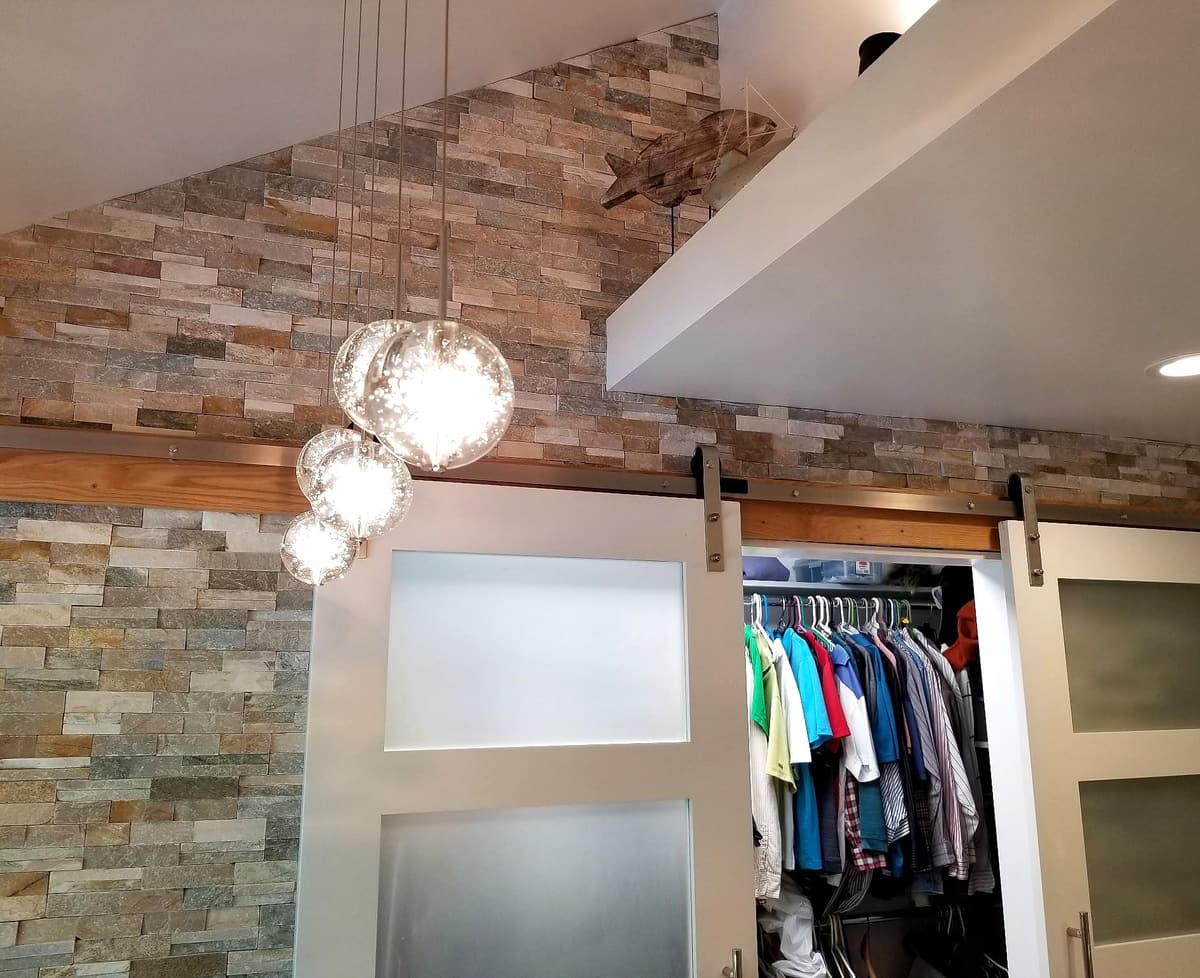 Stone accent wall & walk-in closet by Gene Laughner Construction in Erie, PA
