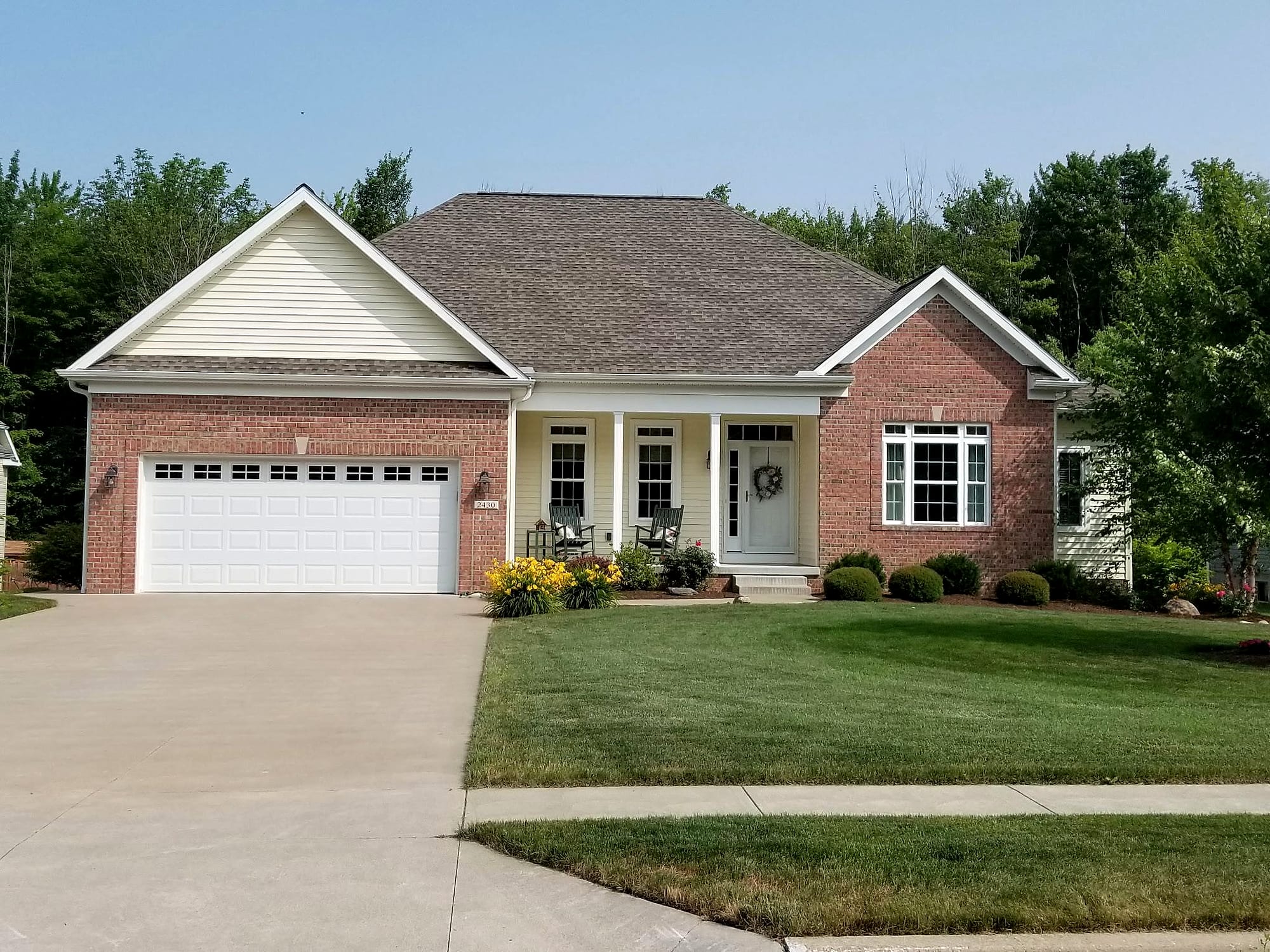 Custom brick home with front porch by Gene Laughner Construction in Erie, PA